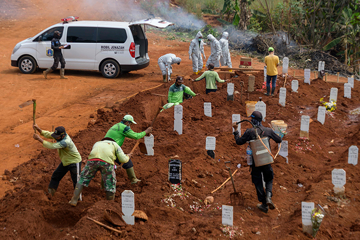 local authorities order anti-maskers to dig graves for covid-19 victims in java, indonesia