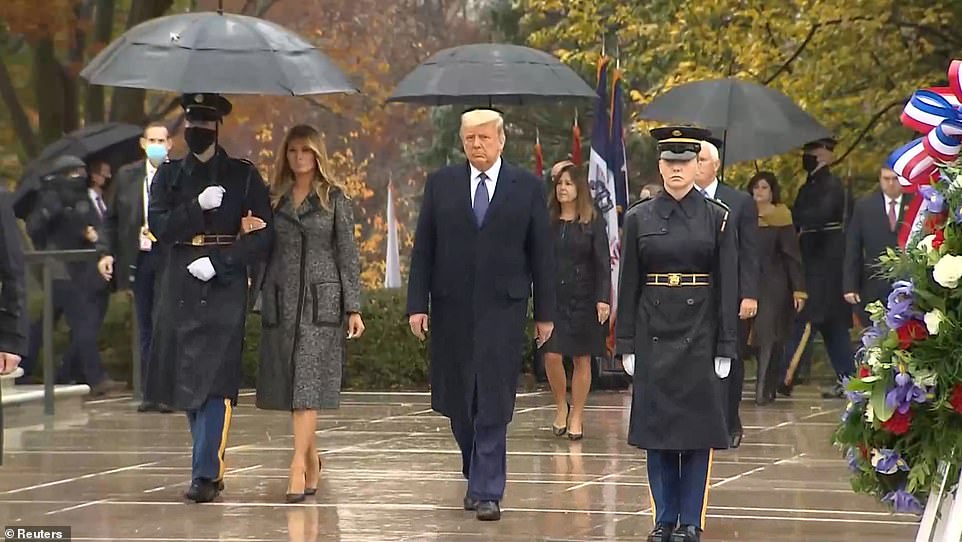 melania trump photo arm-in-arm with a soldier under umbrella goes viral even as donald trump divorce rumors rage