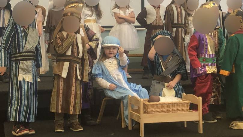 little girl dressed as mary flips off the audience during nativity