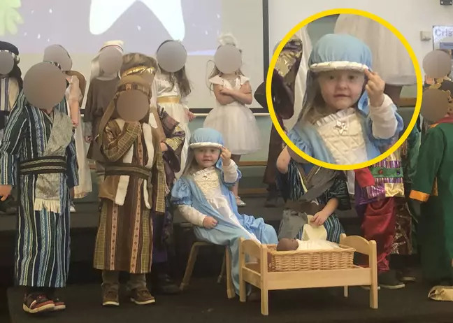 little girl dressed as mary flips off the audience during nativity