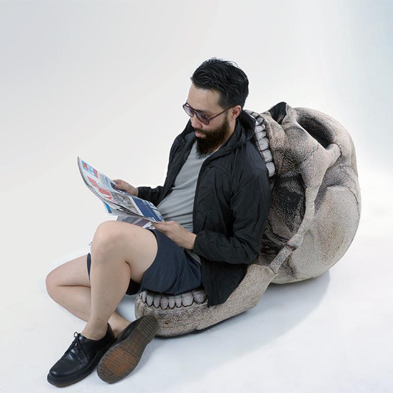 this giant skull chair with movable jaw is must-have furniture for your halloween