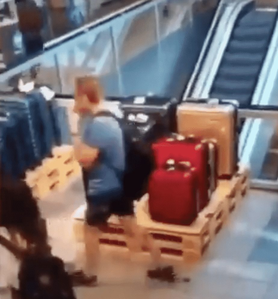 man casually shits on the floor while walking through airport, another man slips and falls in it