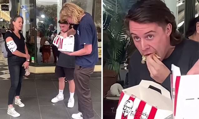 ‘do you want a bite?’ two men taunt vegan protesters by eating a kfc zinger box in front of them