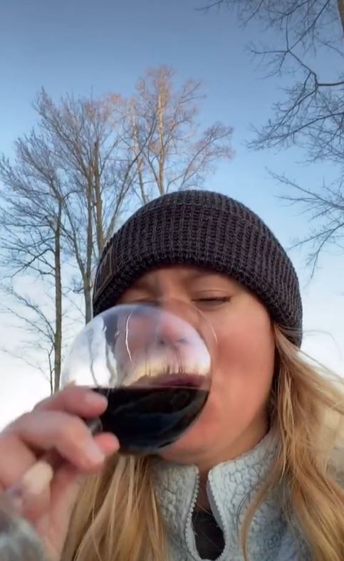 mortified woman posts wine glass photo without noticing r-rated reflection