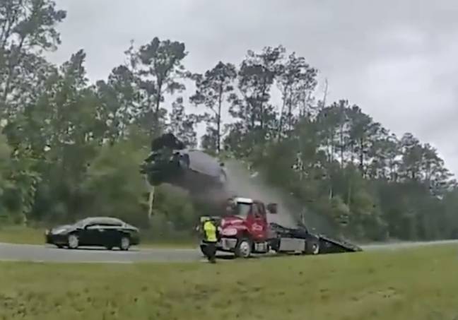 Dramatic Video Captures Car Flying 120ft After Crashing Into Parked Tow Truck Ramp